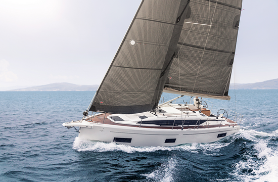 Teak deck of a classic sailing yacht at dusk with coiled ropes and a brass winch